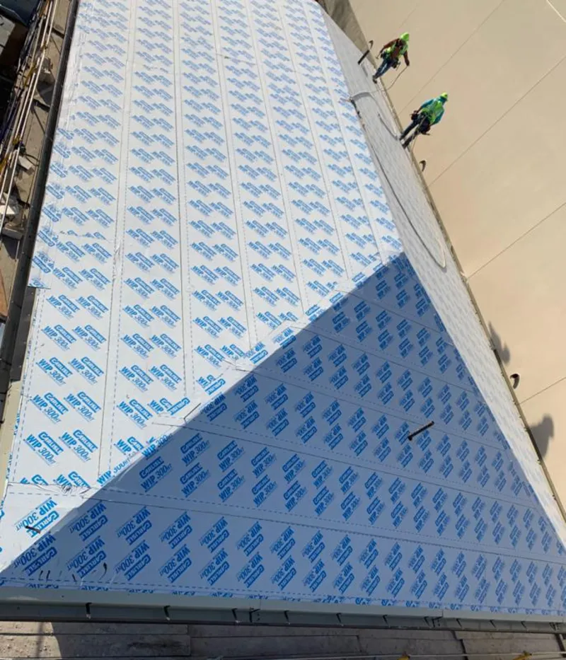 Professional roofers installing underlayment on a metal roof in Lithia Springs